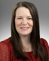 headhshot of Amie Hinshaw in red shirt with long brown hair