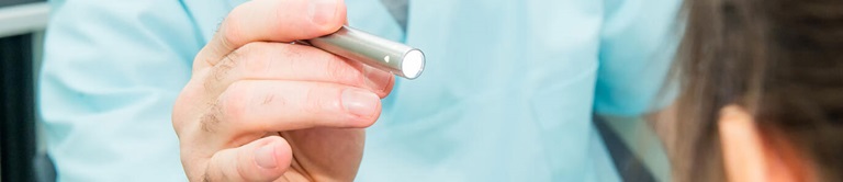 Nurse holding a tool.