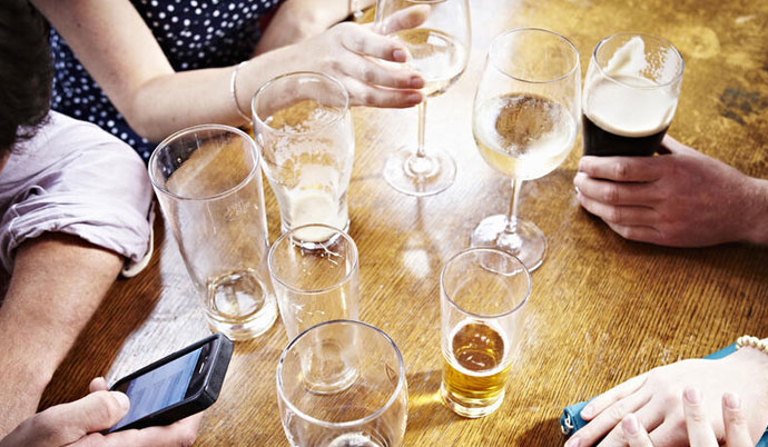 Table with lots of beverages on it.