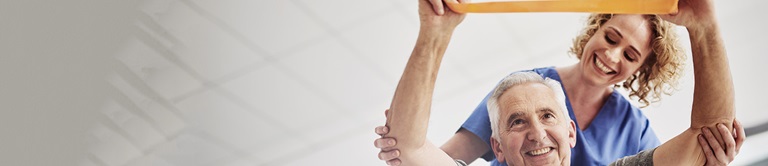 nurse helping an elderly man do strength training