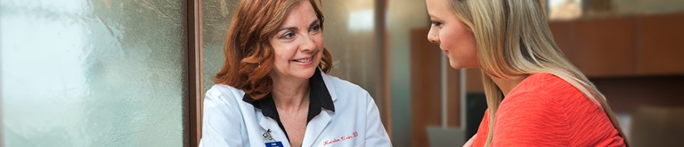 doctor talking to young woman