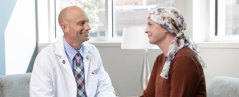Cancer patient talking with doctor