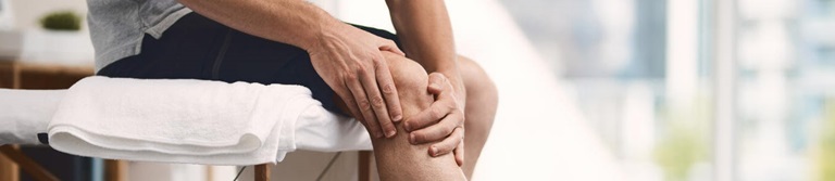 patient holding knee