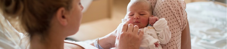 mom looking at newborn baby