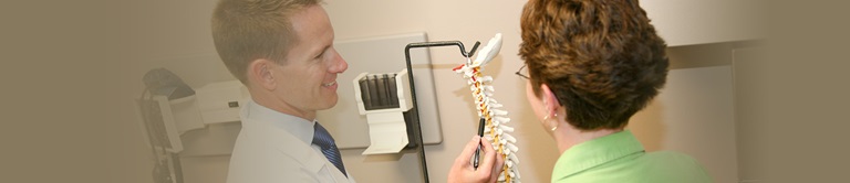 doctor pointing at a spine model