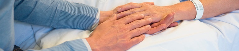 patient and family holding hands