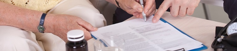 using a pen to put signature on a document