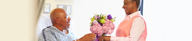 woman giving flowers to a patient