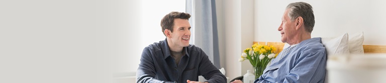 young man talking to a patient in the hospital