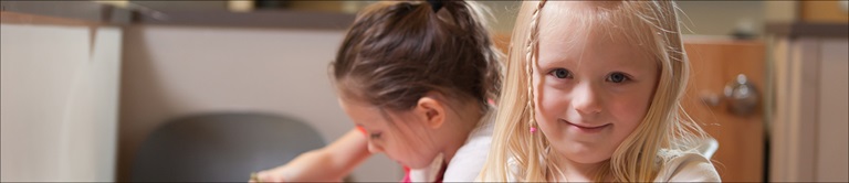two little girls one smiling at camera